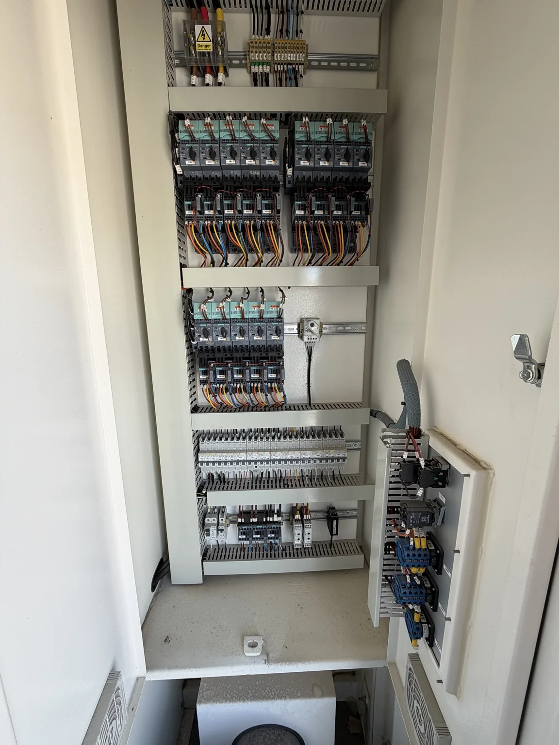 Open commercial load-bank control cabinet showing wiring and control components
