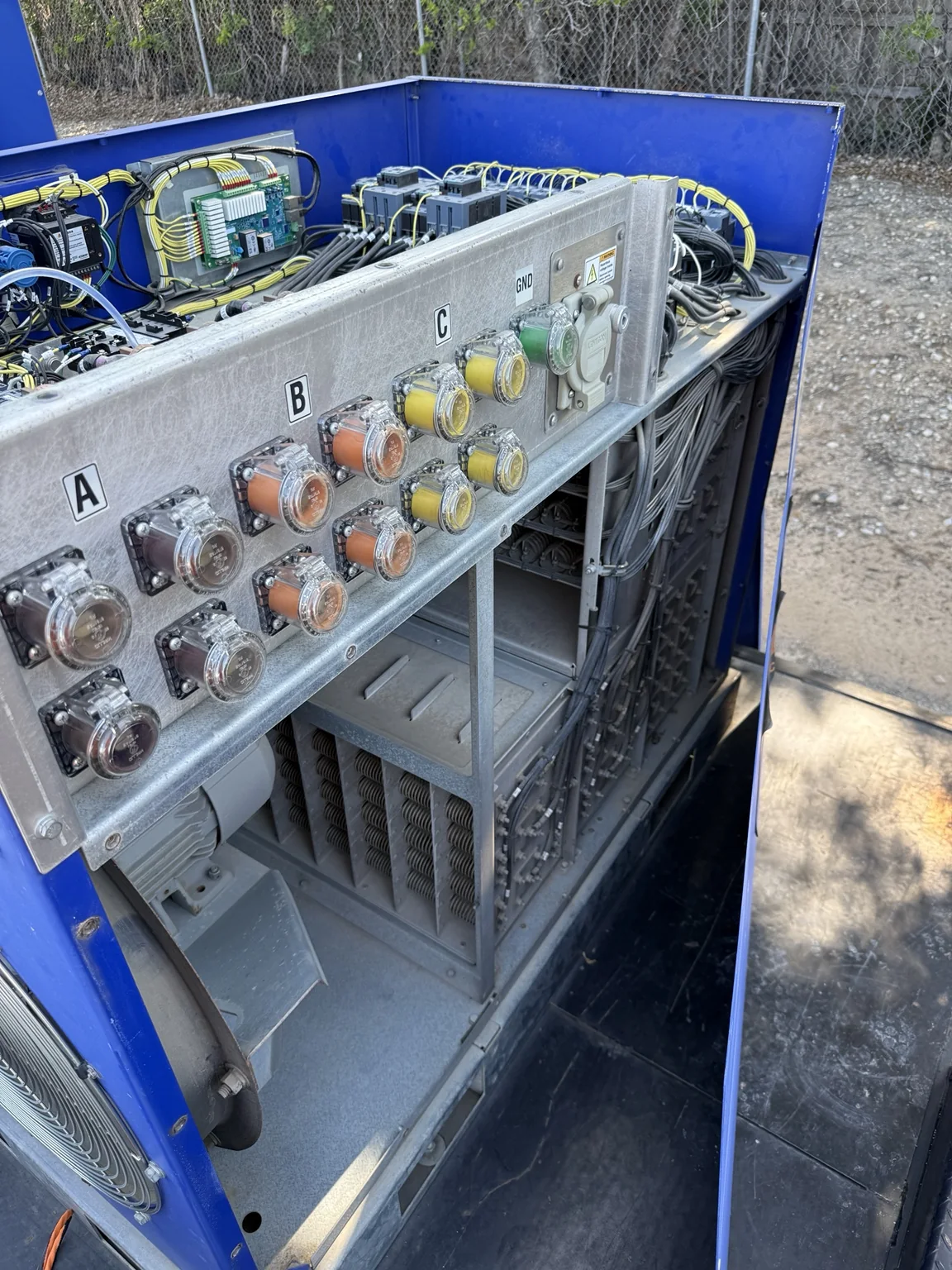 Open blue commercial load bank undergoing service work
